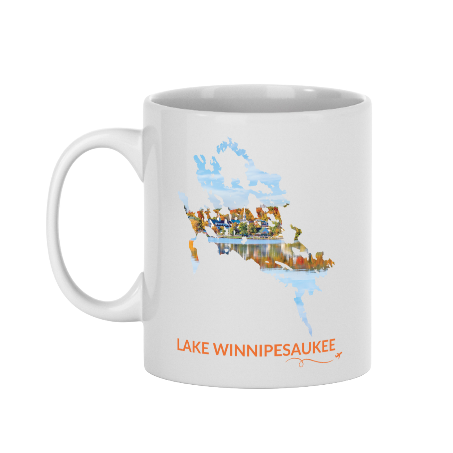 White 11 oz ceramic mug featuring a hand-drawn outline of Lake Winnipesaukee filled with a photograph of Meredith, New Hampshire, with colorful fall foliage, lakeside buildings, and reflections on the water. The words “Lake Winnipesaukee” appear below the artwork with a small airplane icon and looping flight path.