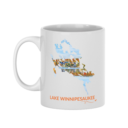 White 11 oz ceramic mug featuring a hand-drawn outline of Lake Winnipesaukee filled with a photograph of Meredith, New Hampshire, with colorful fall foliage, lakeside buildings, and reflections on the water. The words “Lake Winnipesaukee” appear below the artwork with a small airplane icon and looping flight path.