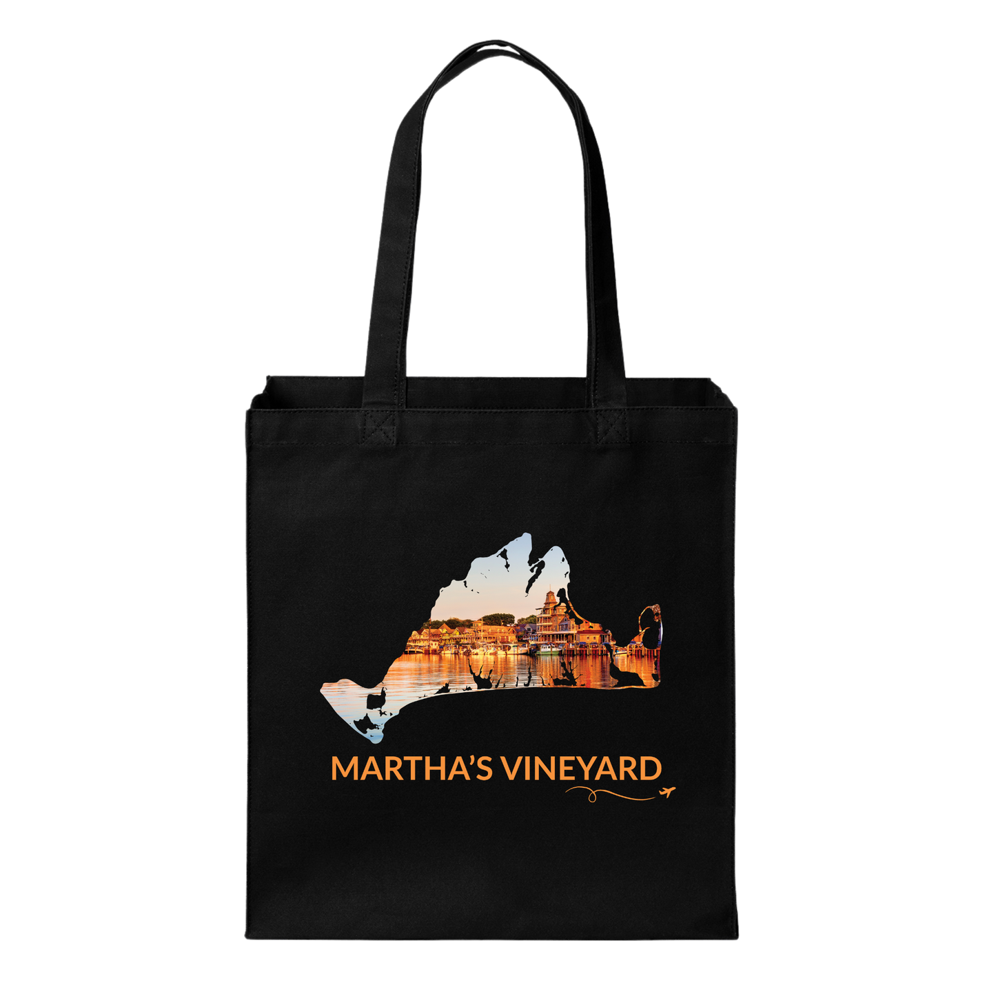 Black cotton canvas tote bag featuring a hand-drawn Martha's Vineyard outline filled with Oak Bluffs Harbor at sunset, with boats, waterfront buildings, and golden reflections on the water. The words "Martha's Vineyard" appear below the artwork with a small airplane icon and looping flight path.