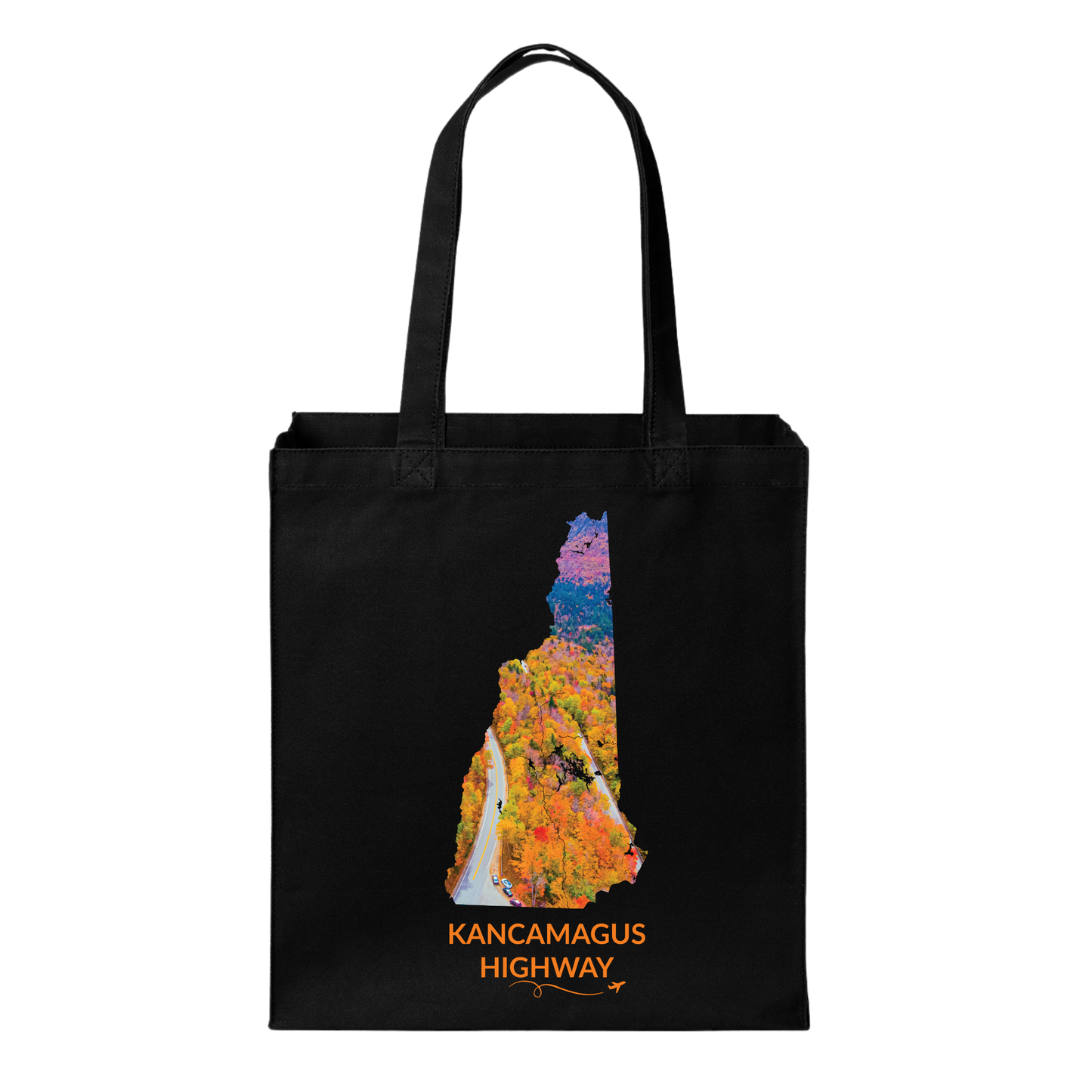 Black canvas tote bag featuring a hand-drawn New Hampshire outline filled with an aerial photograph of the Kancamagus Highway winding through colorful fall foliage. The words “Kancamagus Highway” appear below with a small airplane icon and looping flight path.