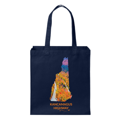 Navy canvas tote bag featuring a hand-drawn New Hampshire outline filled with an aerial photograph of the Kancamagus Highway winding through colorful fall foliage. The words “Kancamagus Highway” appear below with a small airplane icon and looping flight path.