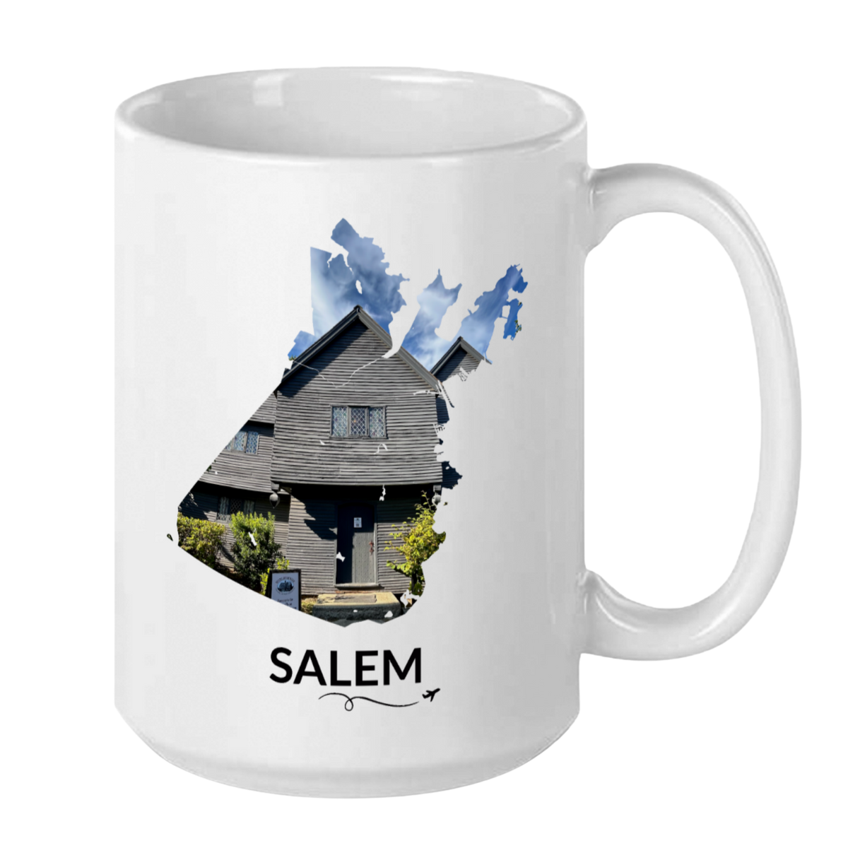 White 15 oz Salem, Massachusetts mug featuring a hand-drawn Salem outline filled with a real photograph of the Witch House, SALEM lettering underneath, and a plane with a swirl line.