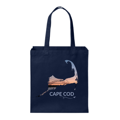 Navy Cape Cod tote bag featuring the Bourne Bridge at sunset inside the Cape Cod outline, light blue Cape Cod lettering, and a small airplane with swirl