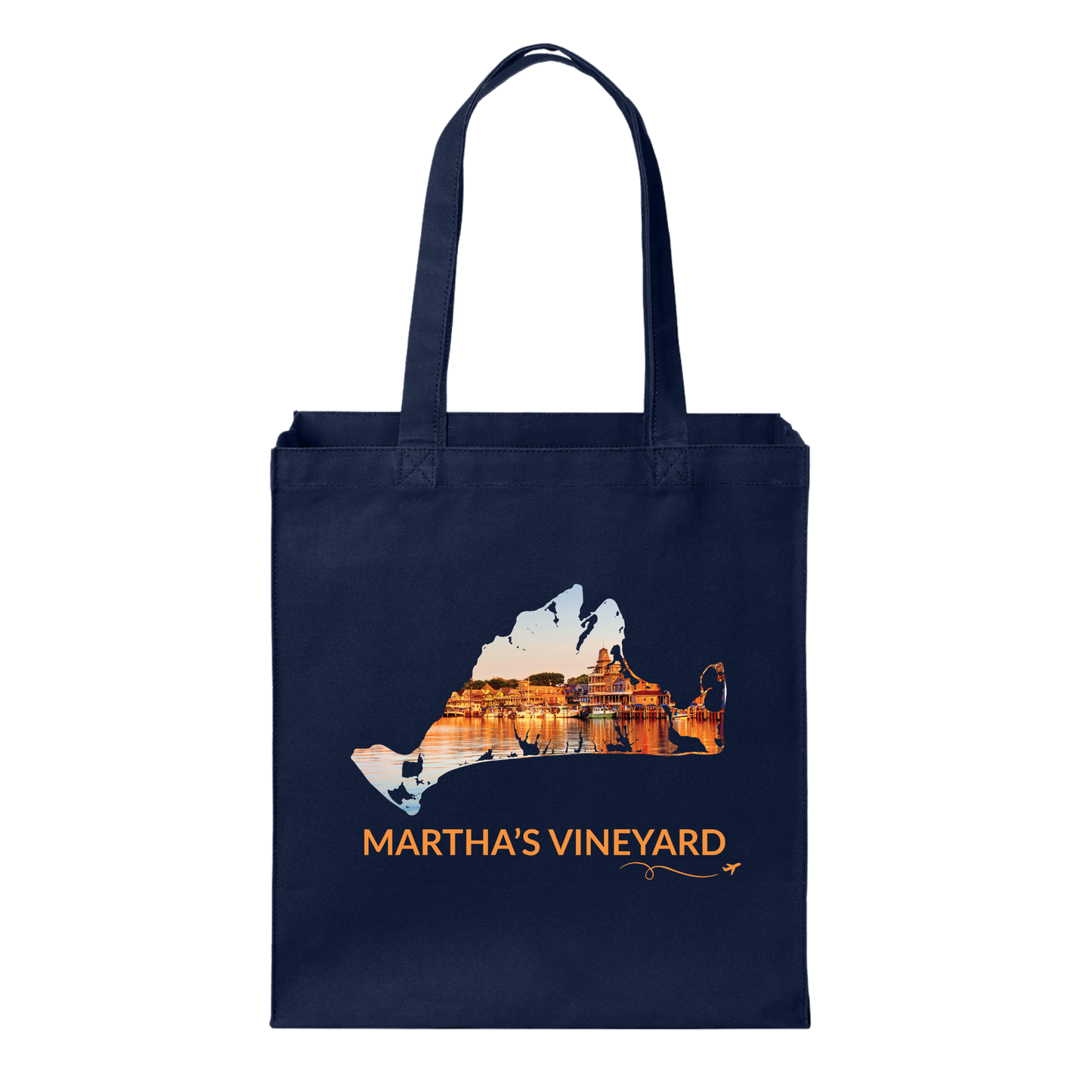Navy cotton canvas tote bag featuring a hand-drawn Martha's Vineyard outline showcasing Oak Bluffs Harbor at sunset with glowing waterfront buildings reflected in the harbor. The words "Martha's Vineyard" appear below the artwork with a small airplane icon and looping flight path.