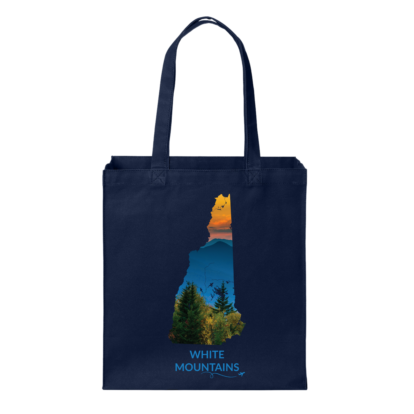 Navy canvas tote bag featuring a hand-drawn New Hampshire outline filled with a photograph of the White Mountains, evergreen trees, and sunset. The words “White Mountains” appear below with a small airplane icon and looping flight path.