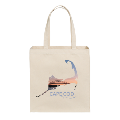 Natural canvas Cape Cod tote bag featuring the Bourne Bridge at sunset inside the Cape Cod outline, blue Cape Cod lettering, and a small airplane with swirl
