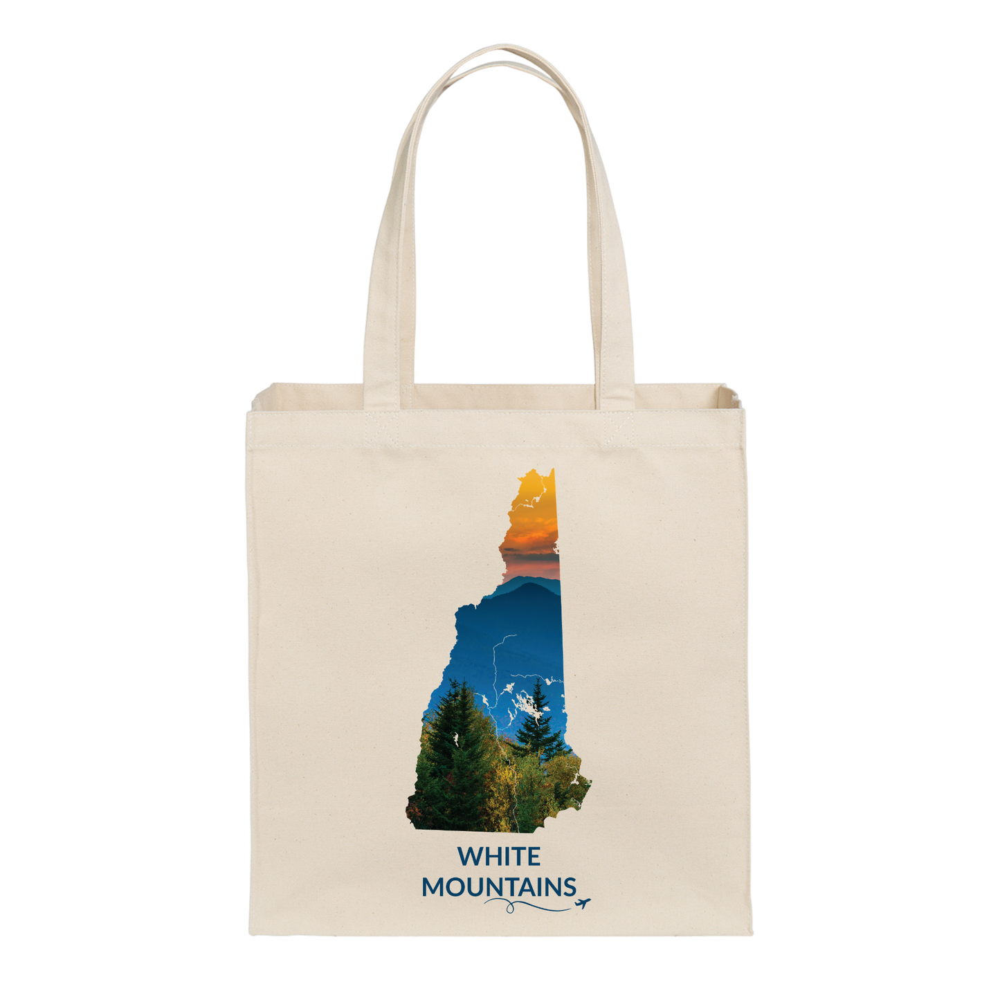 Natural canvas tote bag featuring a hand-drawn New Hampshire outline filled with a photograph of the White Mountains, evergreen trees, and sunset. The words “White Mountains” appear below with a small airplane icon and looping flight path.