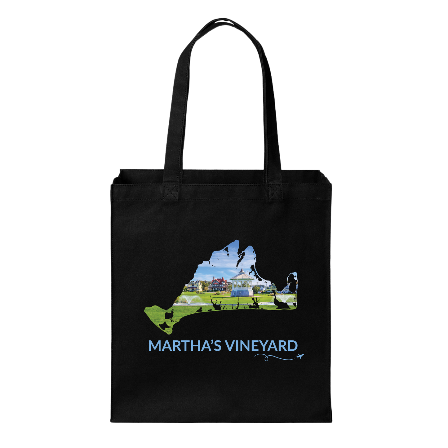 Black cotton canvas tote bag featuring a hand-drawn Martha's Vineyard outline filled with the Ocean Park gazebo, green lawn, and colorful cottages in Oak Bluffs. The words "Martha's Vineyard" appear below the artwork with a small airplane icon and looping flight path.