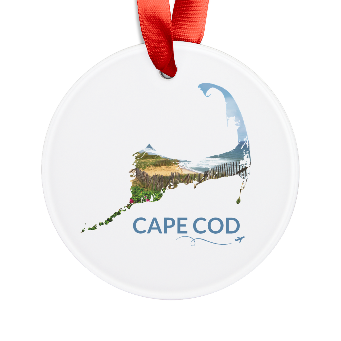 Round ceramic ornament featuring a hand-drawn Cape Cod outline filled with beach roses, weathered sand fencing, rolling dunes, and the Atlantic Ocean. The words "Cape Cod" appear below the artwork with a small airplane icon and looping flight path.