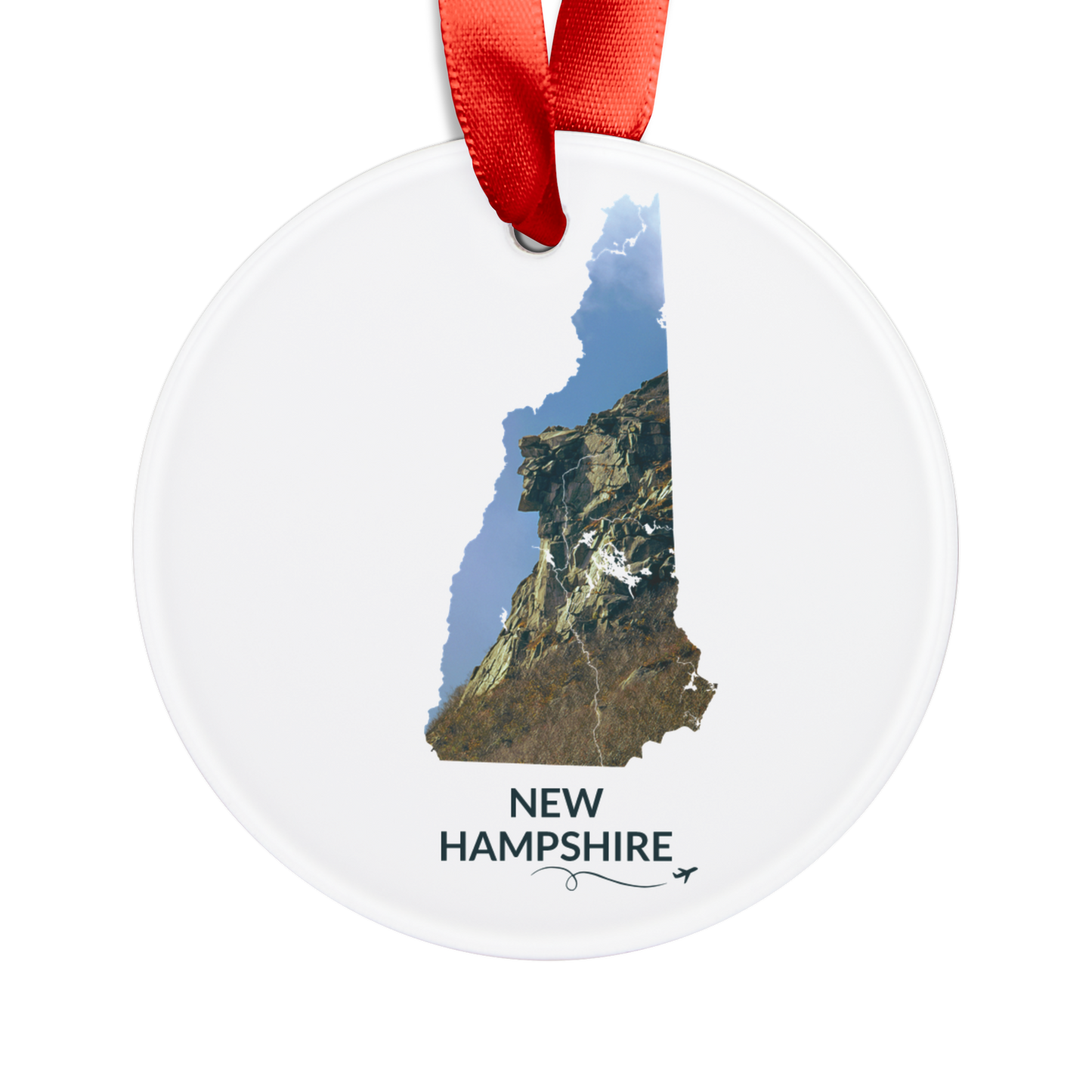 White round ornament featuring a hand-drawn New Hampshire outline filled with the iconic Old Man of the Mountain in Franconia Notch, with “New Hampshire” below and a looping flight path and airplane.