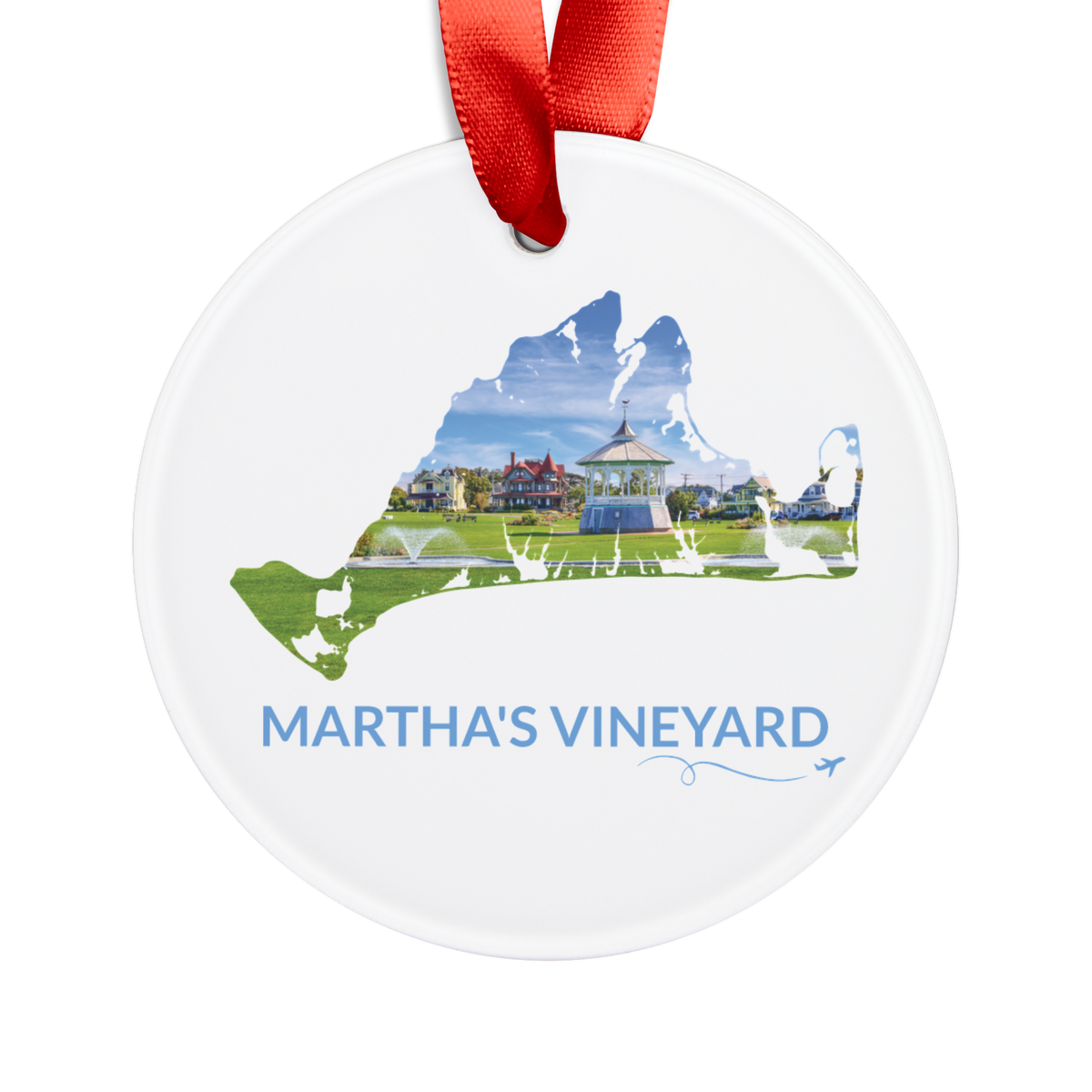White Martha’s Vineyard Ocean Park ornament with red ribbon, featuring the Oak Bluffs gazebo, green lawn and colorful homes inside the island outline, blue Martha’s Vineyard lettering, and a small airplane with swirl