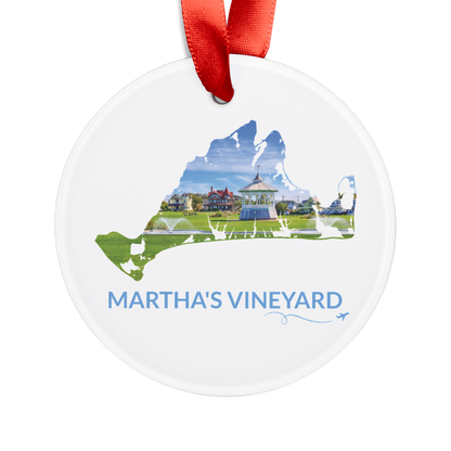 White Martha’s Vineyard Ocean Park ornament with red ribbon, featuring the Oak Bluffs gazebo, green lawn and colorful homes inside the island outline, blue Martha’s Vineyard lettering, and a small airplane with swirl
