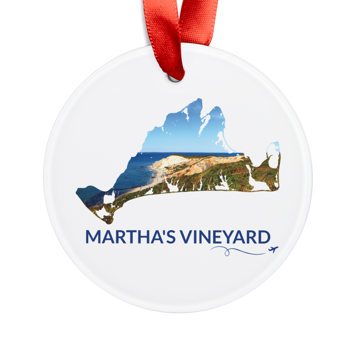 White Martha’s Vineyard Aquinnah Cliffs ornament with red ribbon, featuring a photograph of the cliffs and Atlantic coastline inside the island outline, blue Martha’s Vineyard lettering, and a small airplane with swirl