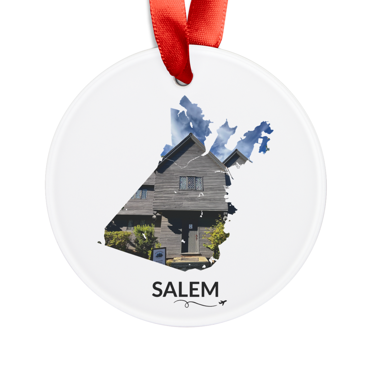 White Salem ornament with red ribbon, featuring the historic Witch House inside the Salem outline, black SALEM lettering, and a small airplane with swirl.