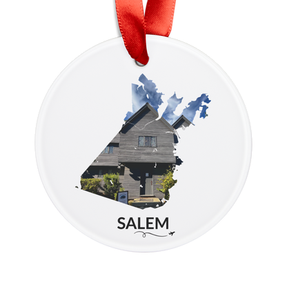 White Salem ornament with red ribbon, featuring the historic Witch House inside the Salem outline, black SALEM lettering, and a small airplane with swirl.