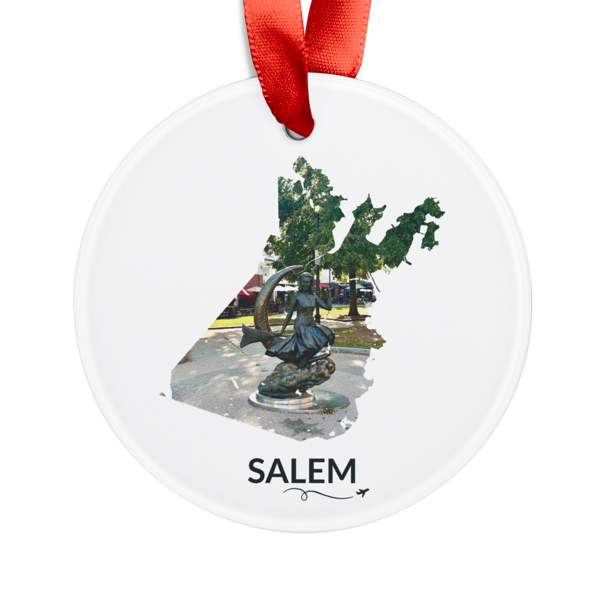 White Salem ornament with red ribbon, featuring the Bewitched Sculpture inside the Salem outline, SALEM lettering, and a small airplane with swirl.
