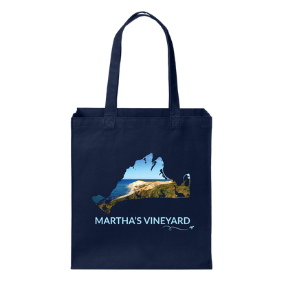Navy cotton canvas tote bag featuring a hand-drawn Martha's Vineyard outline with the Aquinnah Cliffs and Atlantic Ocean inside the outline. The words "Martha's Vineyard" appear below the artwork with a small airplane icon and looping flight path.