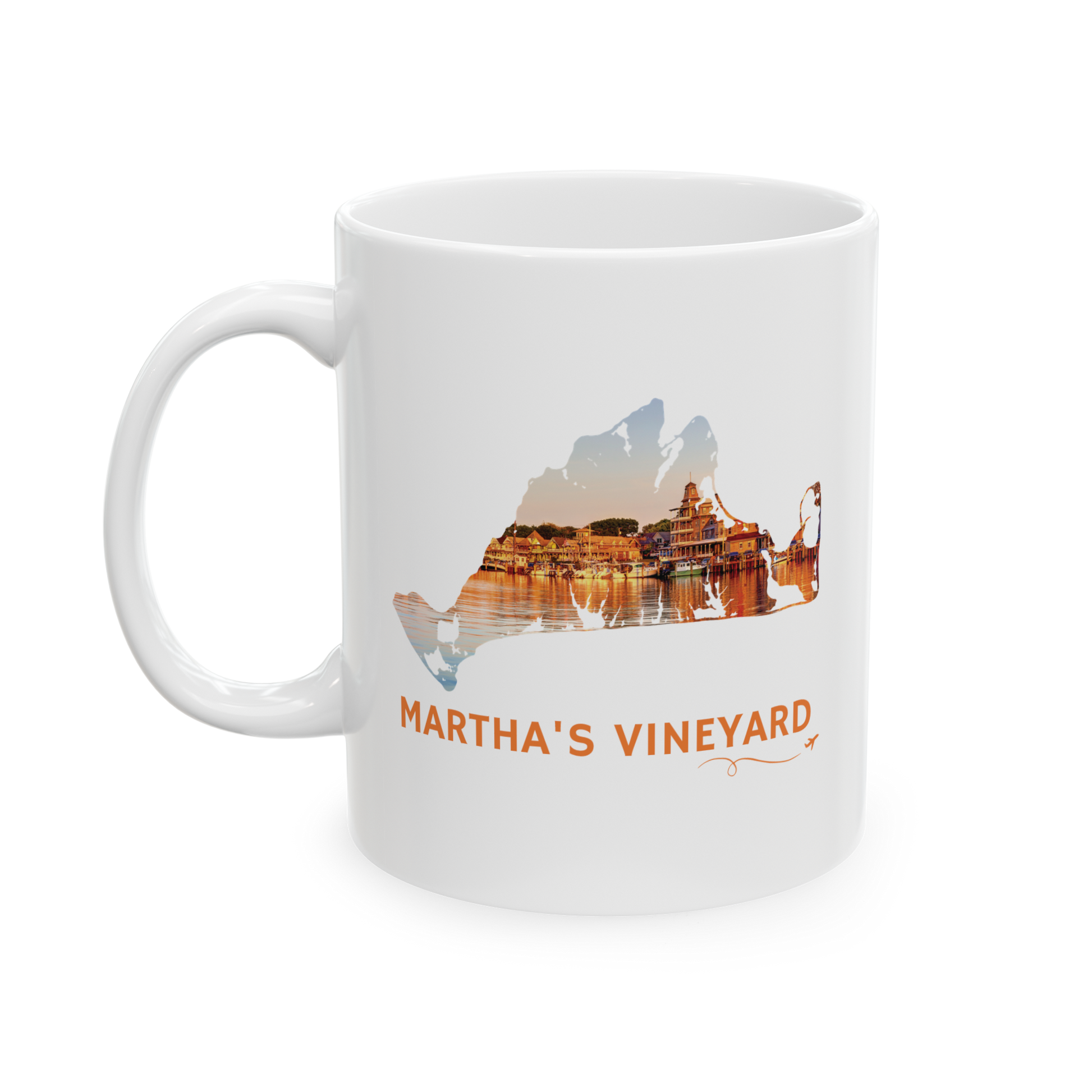 11 oz white ceramic mug featuring a hand-drawn Martha's Vineyard outline filled with a golden sunset over Oak Bluffs Harbor. "Martha's Vineyard" appears below the artwork with a small airplane icon and looping flight path.