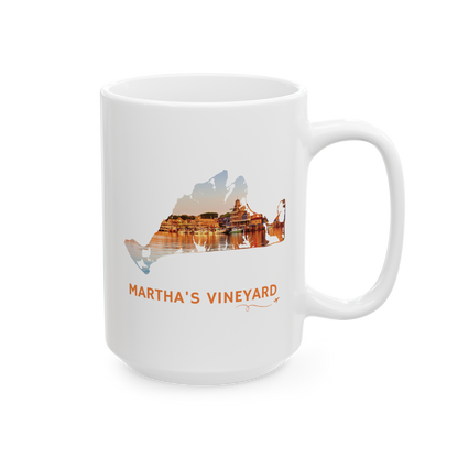 15 oz white ceramic mug featuring a hand-drawn Martha's Vineyard outline showcasing Oak Bluffs Harbor at sunset. "Martha's Vineyard" appears below the artwork with a small airplane icon and looping flight path.