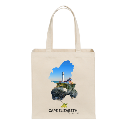Natural canvas Cape Elizabeth tote bag featuring Portland Head Light and the rocky Maine coastline inside the Cape Elizabeth outline, black Cape Elizabeth lettering, and a small airplane with swirl