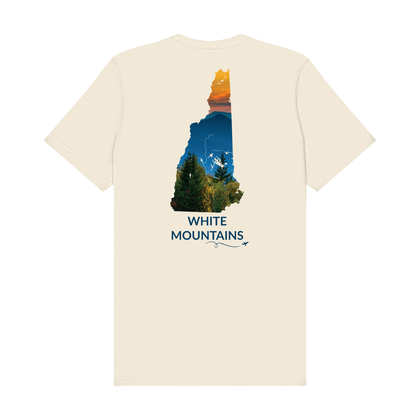 Natural t-shirt featuring a hand-drawn New Hampshire outline filled with a photograph of the White Mountains, with evergreen trees, layered mountain peaks, and an orange sunset sky. The words “White Mountains” appear below the artwork with a small airplane icon and looping flight path.