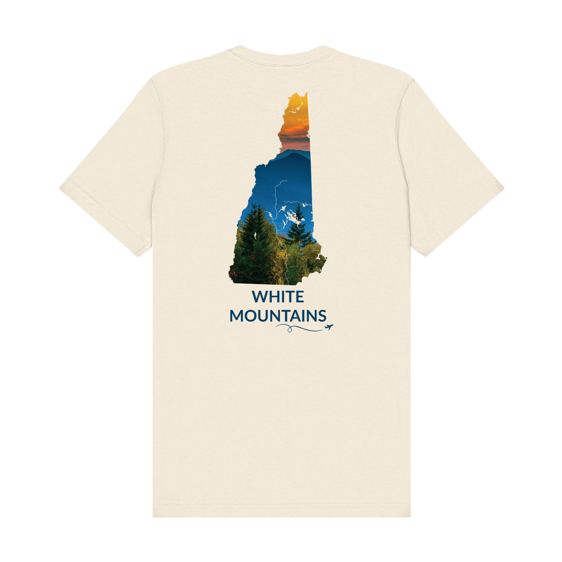 Natural t-shirt featuring a hand-drawn New Hampshire outline filled with a photograph of the White Mountains, with evergreen trees, layered mountain peaks, and an orange sunset sky. The words “White Mountains” appear below the artwork with a small airplane icon and looping flight path.