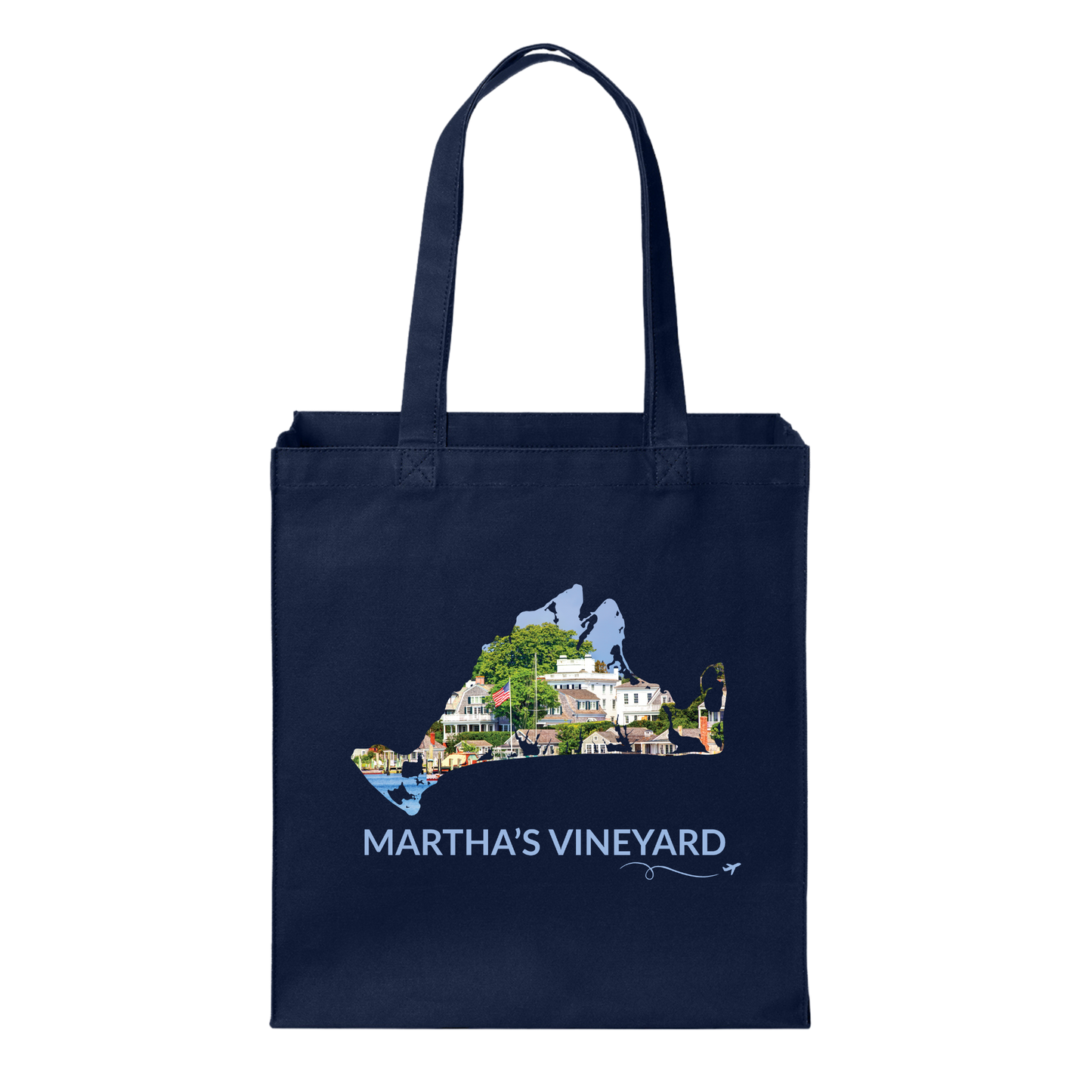 Navy cotton canvas tote bag featuring a hand-drawn Martha's Vineyard outline showcasing Edgartown Harbor with classic New England homes and waterfront views. The words "Martha's Vineyard" appear below the artwork with a small airplane icon and looping flight path.