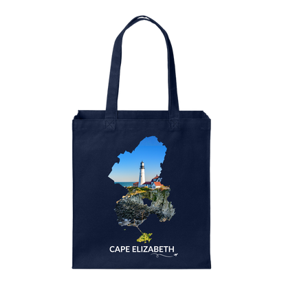 Navy Cape Elizabeth tote bag featuring Portland Head Light and the rocky Maine coastline inside the Cape Elizabeth outline, white Cape Elizabeth lettering, and a small airplane with swirl