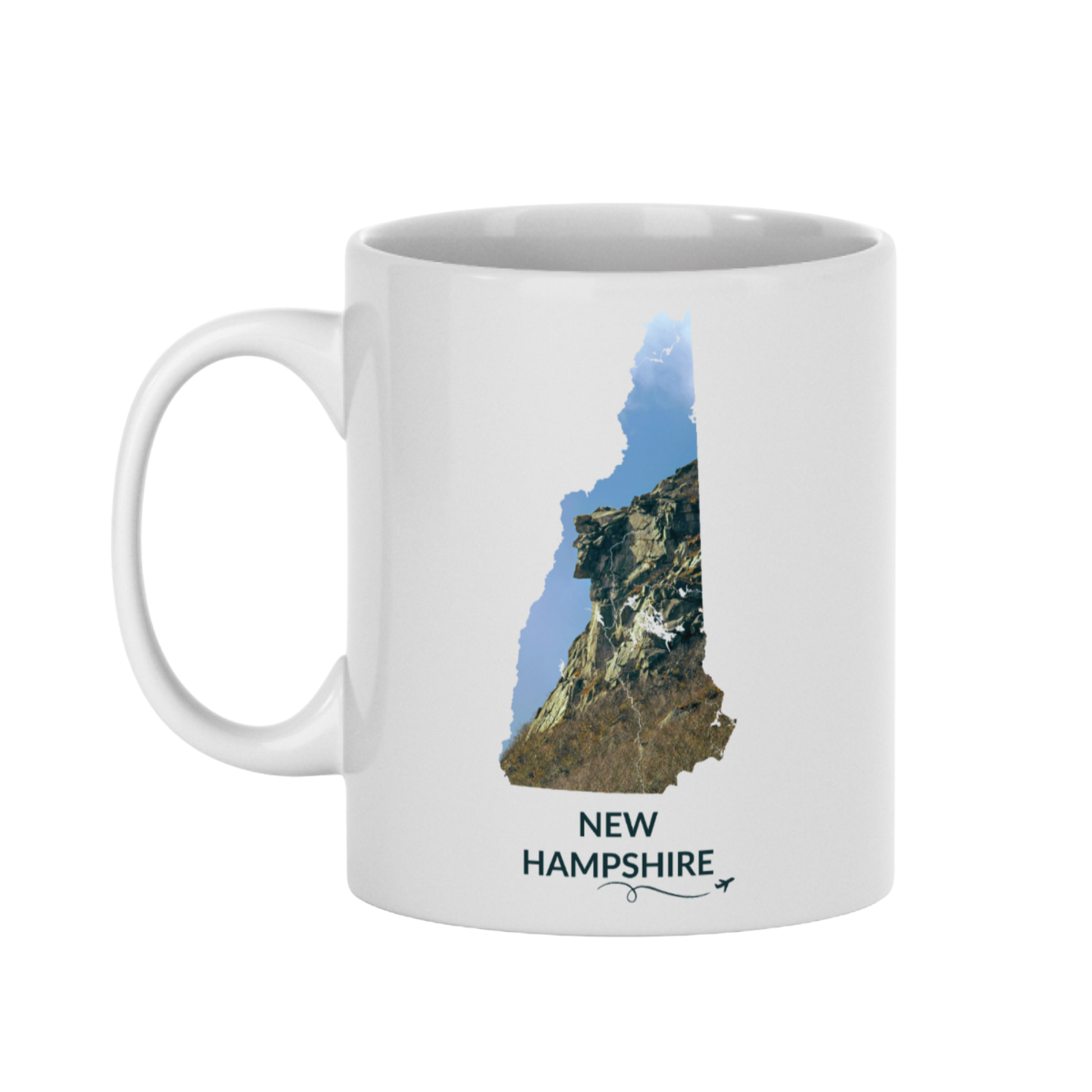 White 11 oz ceramic mug featuring a hand-drawn New Hampshire outline filled with a photograph of the Old Man of the Mountain. The words “New Hampshire” appear below the artwork with a small airplane icon and looping flight path.